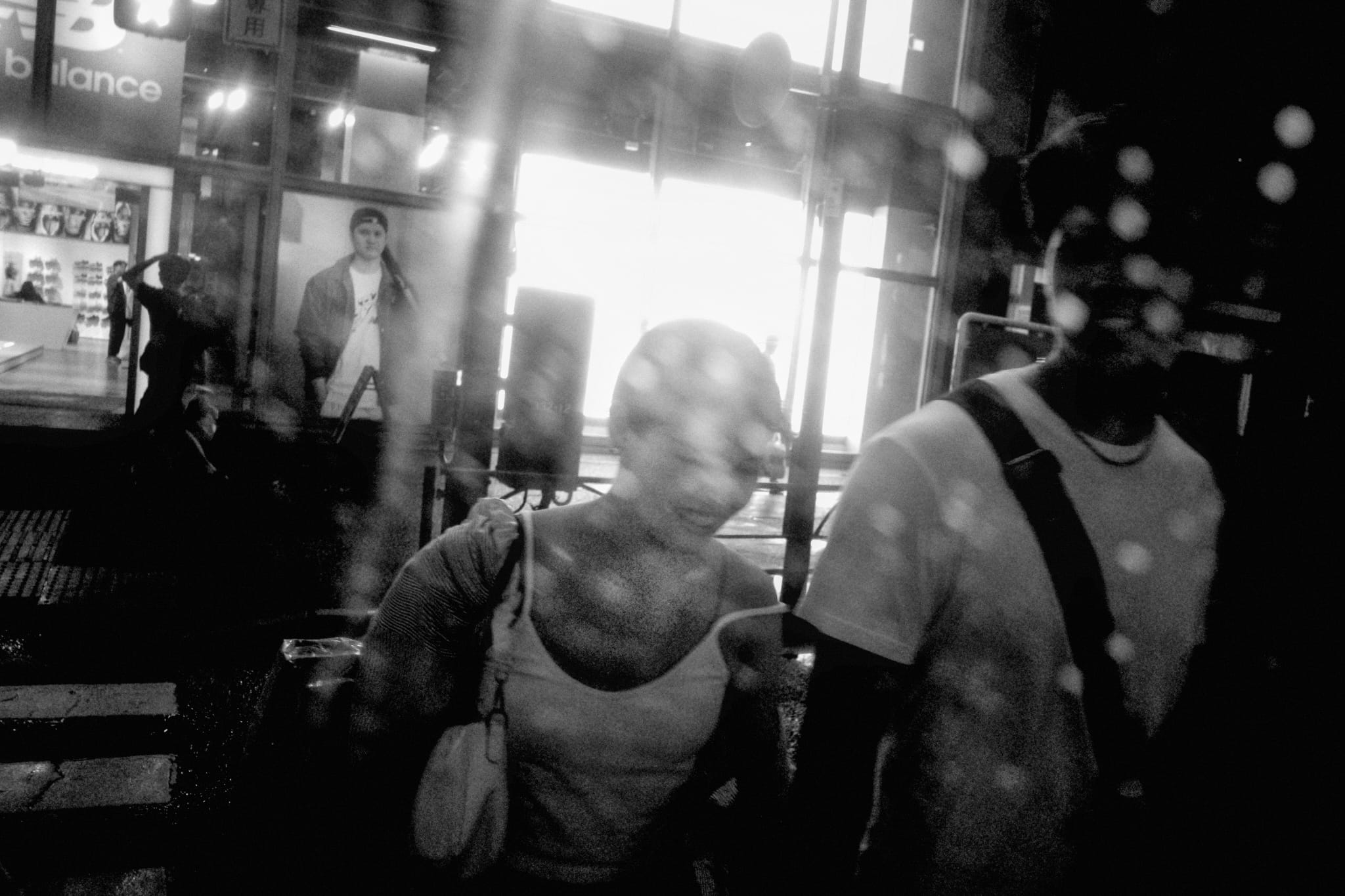 Figures reflected in a shop window
