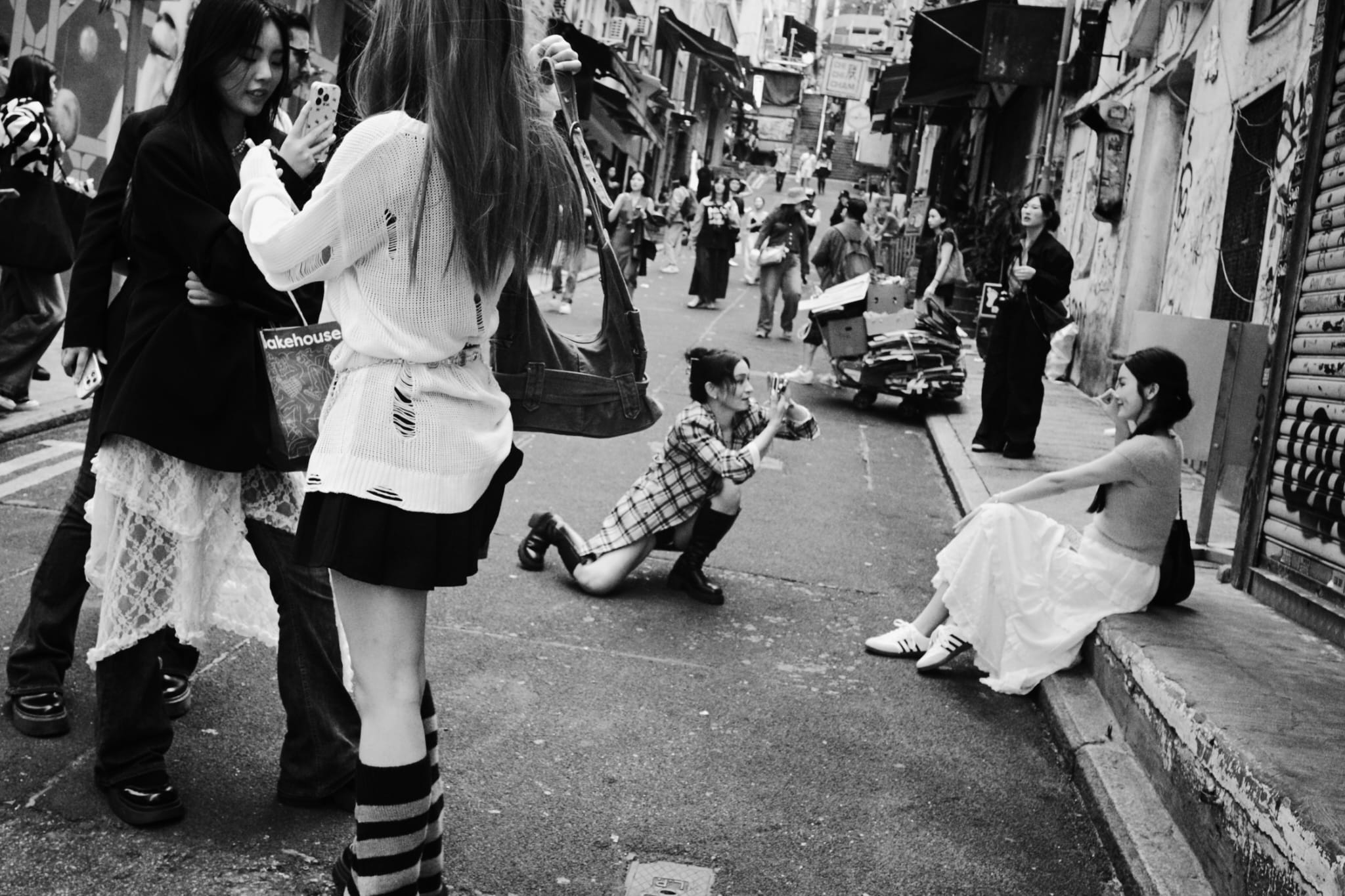 People gathered in a narrow city street