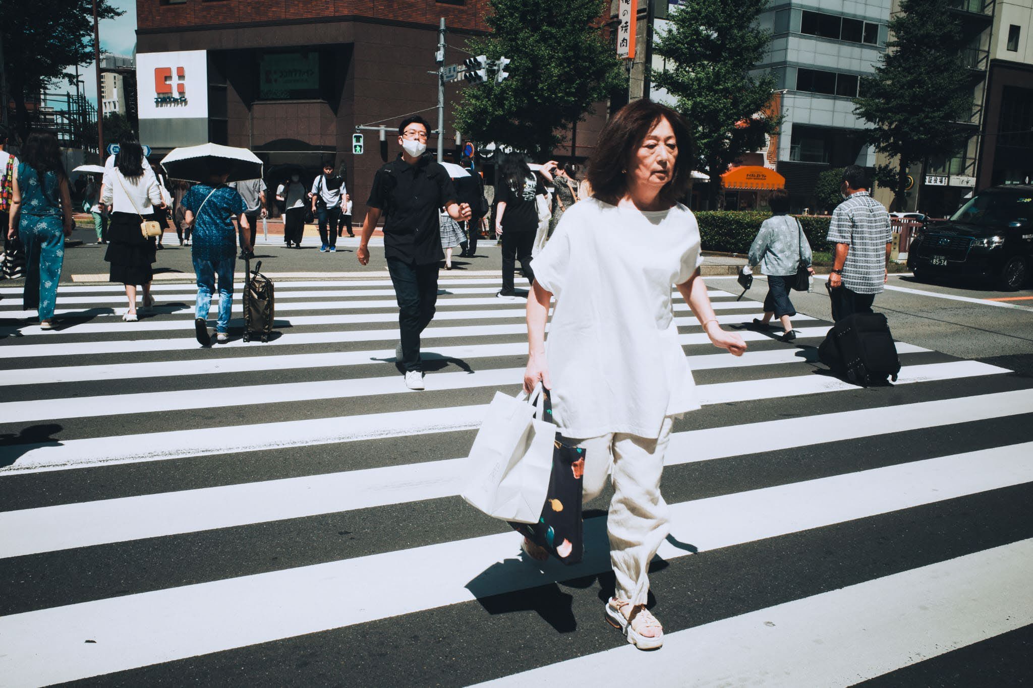 A woman crossing a city street