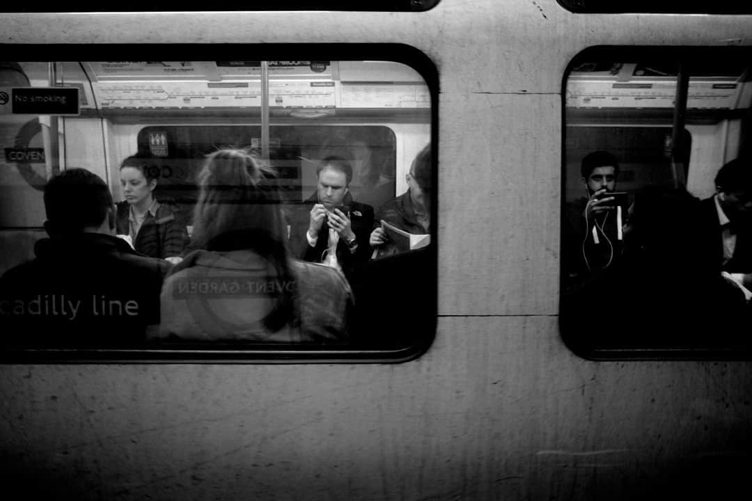 Commuters framed inside a train carriage