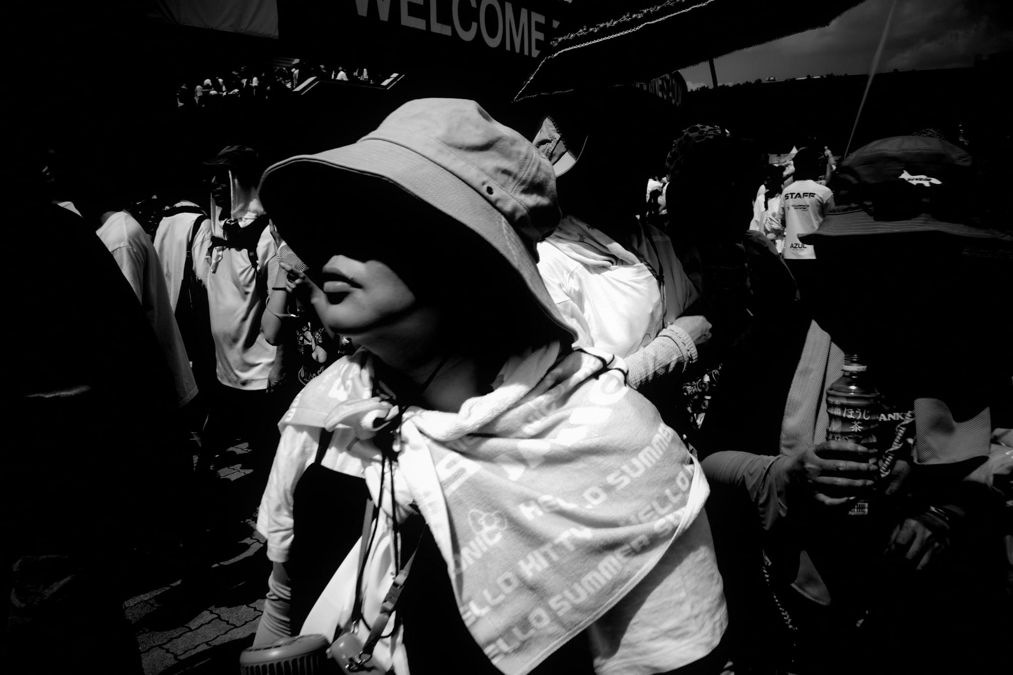 A woman wearing a headscarf among a crowd